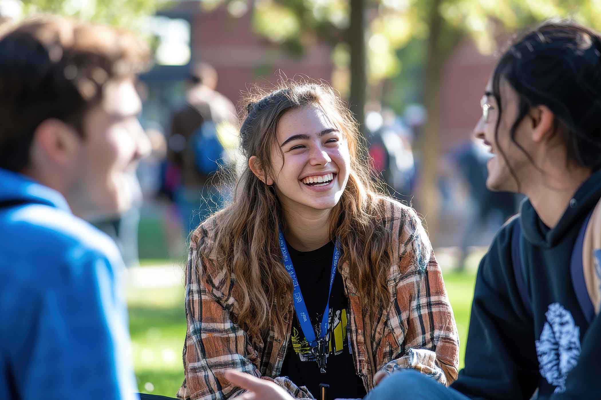 Photo of students sitting outside and laughing